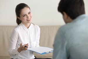 a female counselor explains what is dual diagnosis to a male client